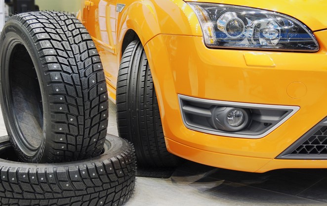 Tyres next to an orange car